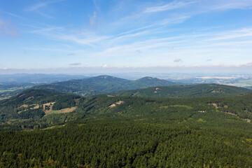 Landscape from the Ještěd mountain in northwest direction. Czech Republic countryside with beautiful nature, forest and hills. Travel destination for hiking and enjoying a panoramic view.