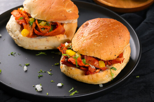 Cemita al pastor with pineapple, onion and cilantro close-up