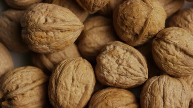 Whole walnuts in shells filling the frame completely