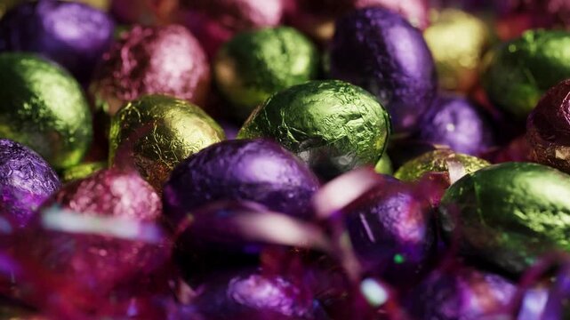 Colorful foil wrapped chocolate Easter eggs with tinsel