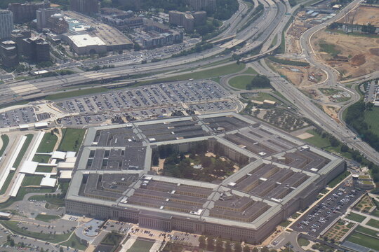 Aerial view of the Pentagon complex with surrounding roads, parking and greenery. g.