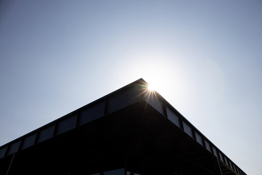 Sunlight glimmers on the edge of a contemporary rooftop