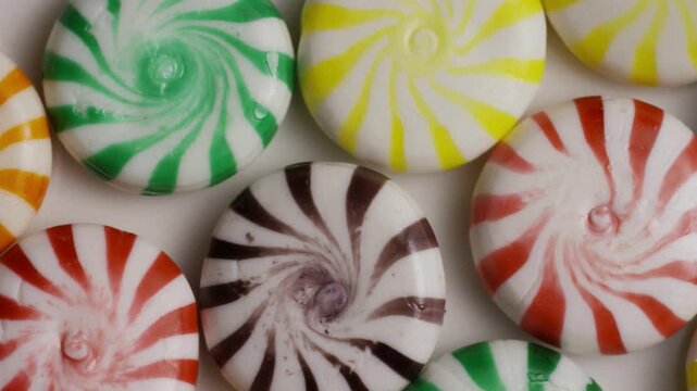Assortment of colorful spiral peppermint candies rotating