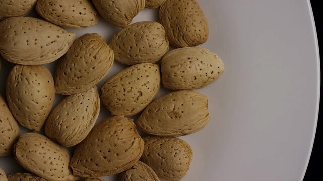 Top view of almonds in shell rotating on plate