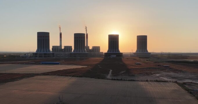 Aerial Sunset Video of Coal Power Plant Cooling Towers in Gobi Desert Inner Mongolia