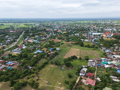 Aerial View of Rural Town with Residential Area, Farmland and Green Landscape