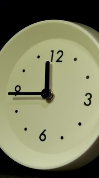 Tme lapse video of a clock time passing over a day to night on black background.