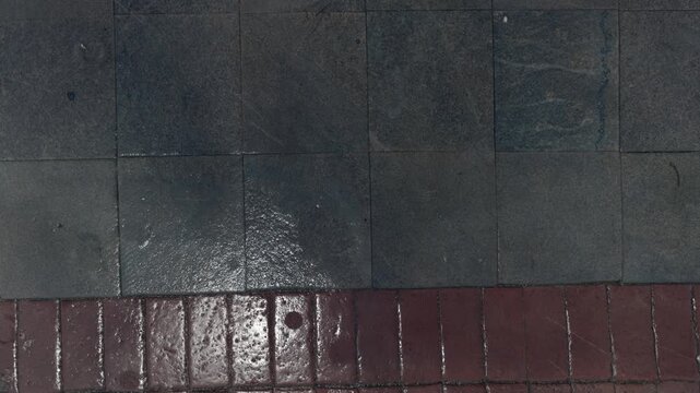 Top Down View of Wet Dark Slate Tiles and Red Brick Floor Texture.