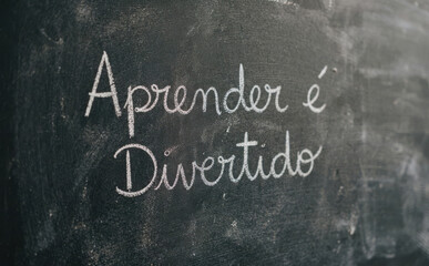 Fototapeta premium Aprender e Divertido escrito a giz em lousa preta representando educacao e escola