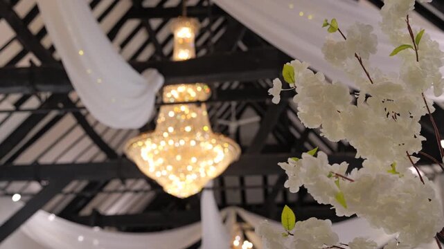 Close-up tracking focus pull on chandelier in elegant wedding venue