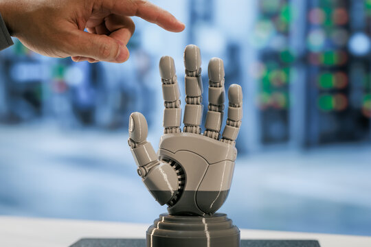 Human hand reaching toward a robotic prosthetic hand in a modern laboratory, connection between people and assistive technology.