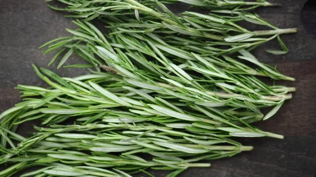 Fresh Rosemary Sprigs on a Dark Wooden Cutting Board