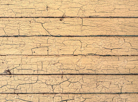 Cracked paint on a wall of wood planks