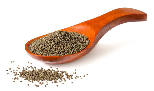 Whole raw poppy seeds isolated on white background.