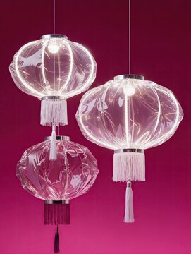 A group of three traditional Chinese lanterns recreated entirely from transparent inflated plastic, different rounded shapes and hanging tassels, soft wrinkles and inflated contours