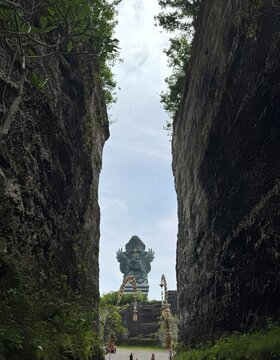 Garuda Wisnu Kencana statue framed by limestone cliffs in Bali Indonesia