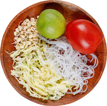 Soto ingredients shredded cabbage bean sprouts glass noodles lime tomato in wooden bowl isolated on transparent background
