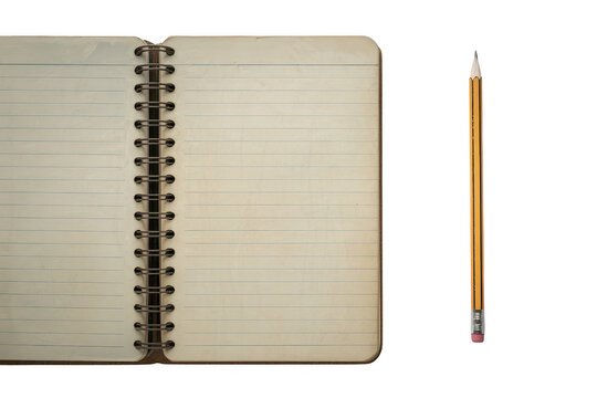 An open spiral bound notebook with lined paper pages placed next to a single yellow wooden pencil on a solid black background