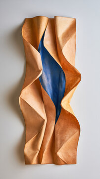 Soft, wavy material in warm copper tones