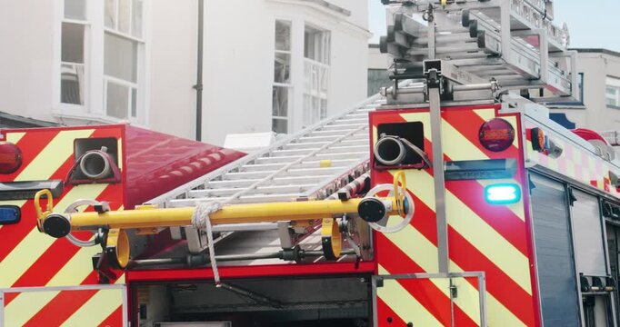 Fire truck emergency service vehicle with flashing lights. Red fire engine with ladders, firefighting apparatus and water to save lives, extinguish fires and assist vehicle collision.