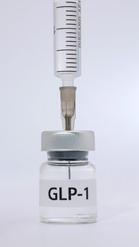 Medical syringe drawing liquid medication from vial labeled glp 1 injection offers hopeful therapy for diabetes management