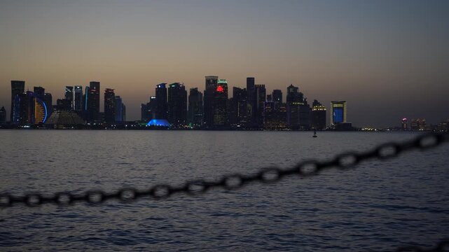 Doha West Bay skyline at sunset with blurred nautical chain