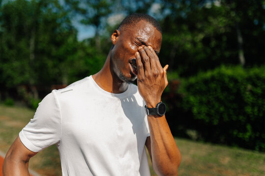 Male runner feeling exhausted and frustrated after training