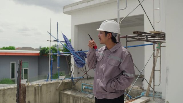 Construction inspector safety helmet walkie talkie building site scaffolding worker communication engineer architecture urban development project outdoor industry professional inspection structure