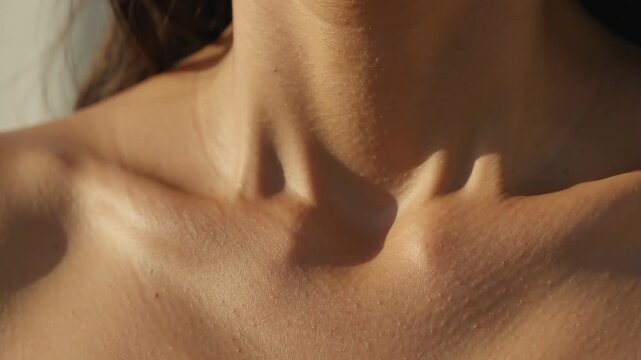 Close Up of Sunlit Bare Woman Collarbone and Decollete Breathing in Deep Relaxation