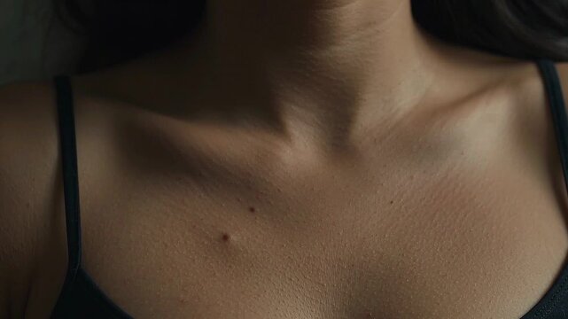 Close Up of Bare Woman Collarbone and Decollete Breathing with Natural Skin Moles
