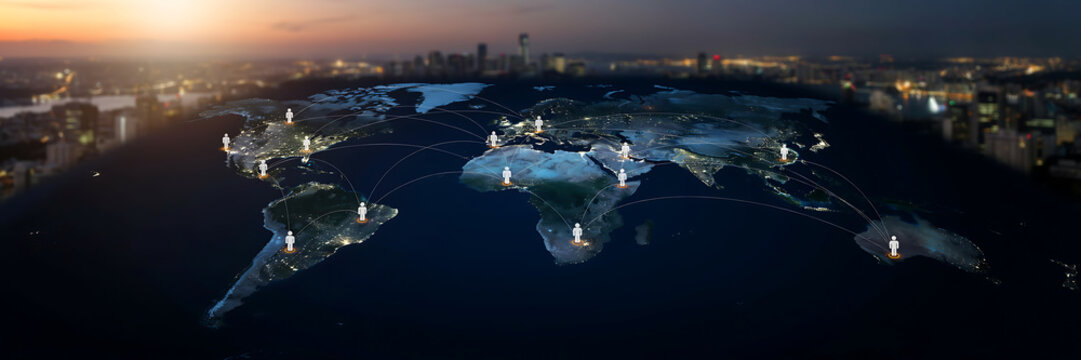 Miniature illuminated world map with tiny human figures during twilight