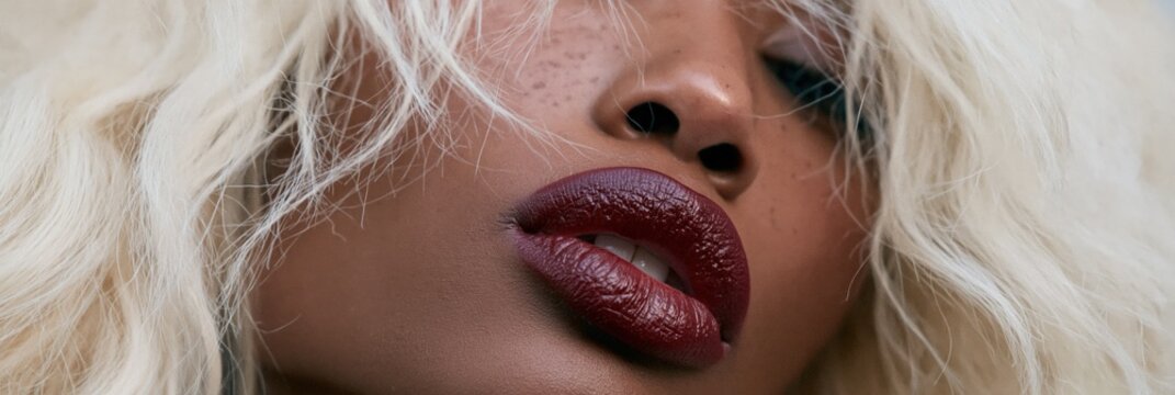 Panoramic closeup dark skin fashion crop with platinum blonde hair and deep burgundy lips for beauty banner and editorial layout design