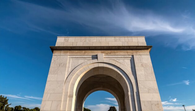 White marble memorial arch under a clear blue sky