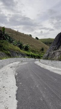 Person Running on a Mountain Road
