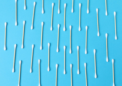 Cotton swabs on a colored background (top view)

