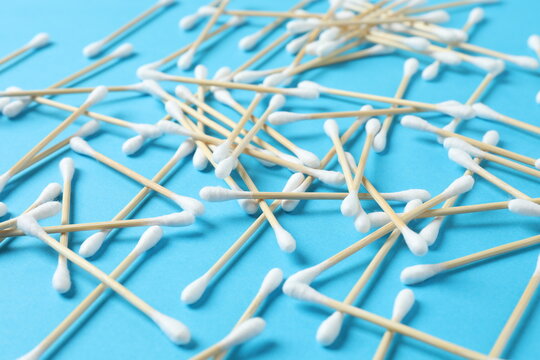 Cotton swabs on a colored background (top view)
