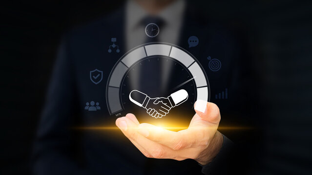 Partnership Trust and Performance Concept. Corporate Relationships. Businessman Showing Confidence Meter with Handshake Icon on Virtual Screen. Collaboration, Commitment, Teamwork and Mutual Success