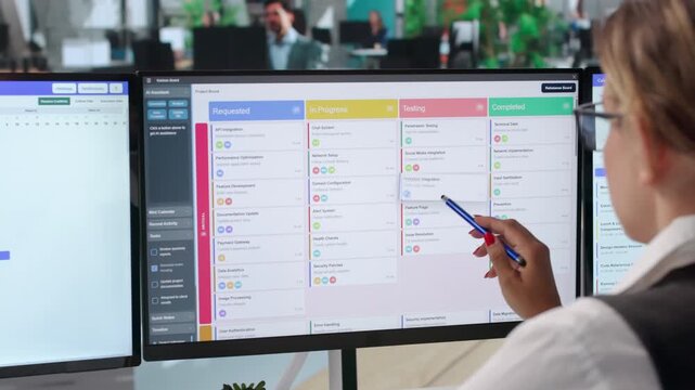 Agile Project Manager Reviews Task Board And Updates Schedule