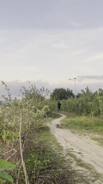 Man Jogging on a Dirt Path Outdoors