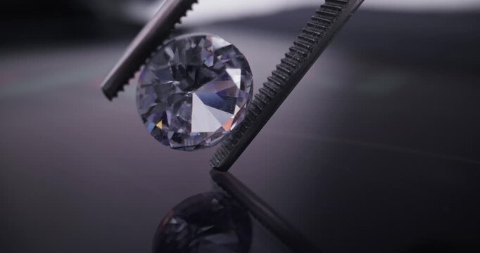 Tweezers holding round brilliant diamond over reflective screen showing green and red market candlestick chart, probe lens view.