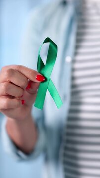 Woman Holds A Teal Ribbon In Her Palm