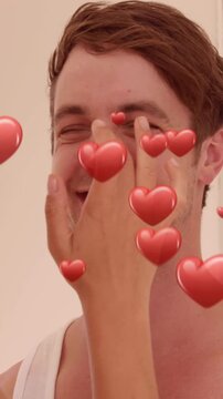 Animation of red hearts over couple in love smiling