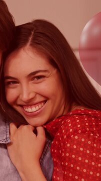 Animation of red heart over couple in love smiling