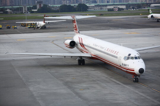 A commercial passenger airplane taxis on the airport runway during operations.