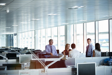 Fototapeta premium Business people, talk and listening to ideas in meeting, financial evaluation or plan for assignment. Coworking, team and mature colleagues with project, discussion and wealth management in office