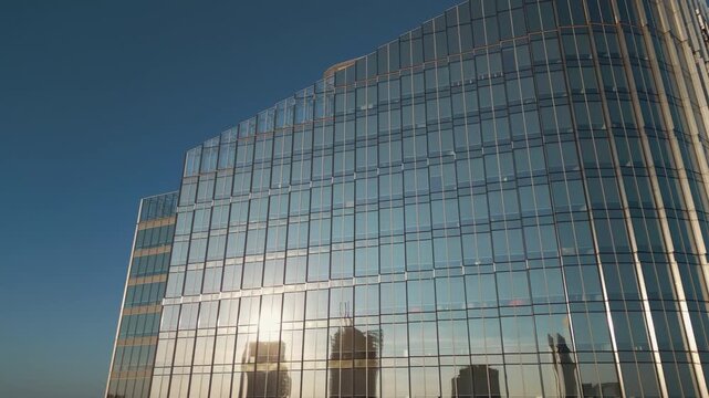 exterior of modern office building from glass and steel, city reflection in mirrors, contemporary architecture of financial district