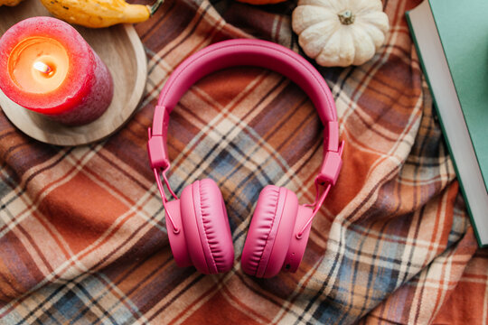 Autumn hygge setup with book and listening headphones