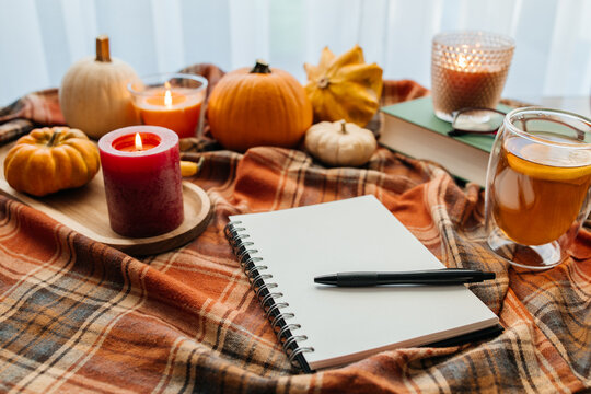 Autumn coziness with candles, pumpkins, and journaling