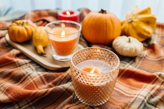 Cozy autumn still life with pumpkins and burning candles