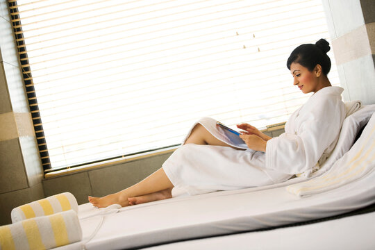 Woman reading a magazine at a spa 